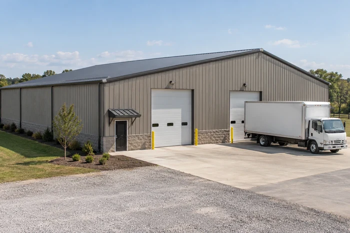 Warehouse storage building with grade-level loading doors and a box-truck approach.